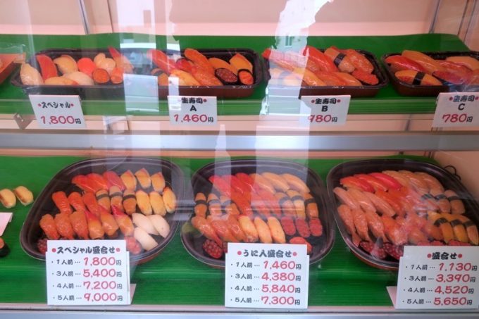 ショーケースに並ぶ寿司盛り合わせの食品サンプル。