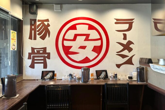 豊見城市「豚骨ラーメン まる・安」窓際カウンター席側にあるお店のロゴがカッコよい